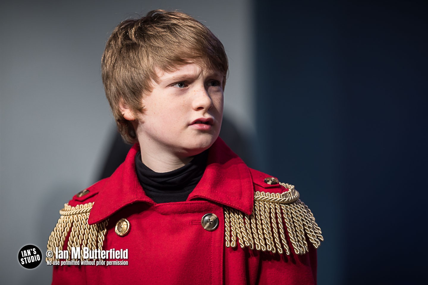 A boy in a red tin soldier coat