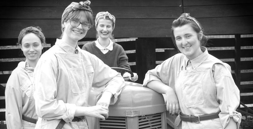 Women stood around a tractor