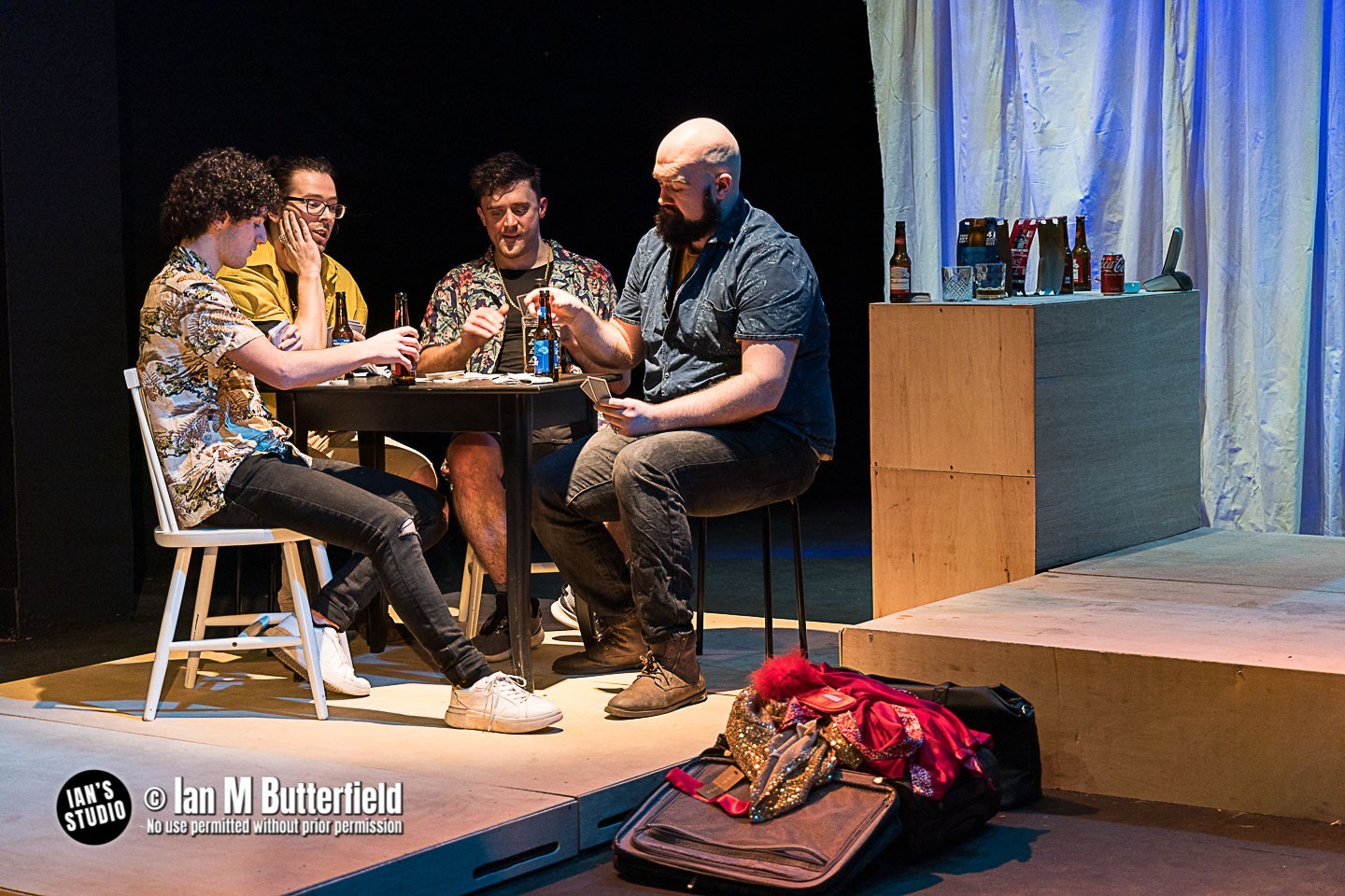 4 men play poker at a table