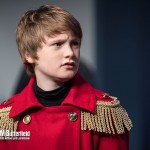 A boy in a red tin soldier coat